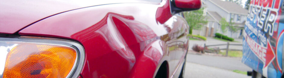 A close up of the side of a red car