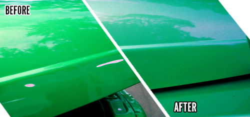 A close up of the side of a green car